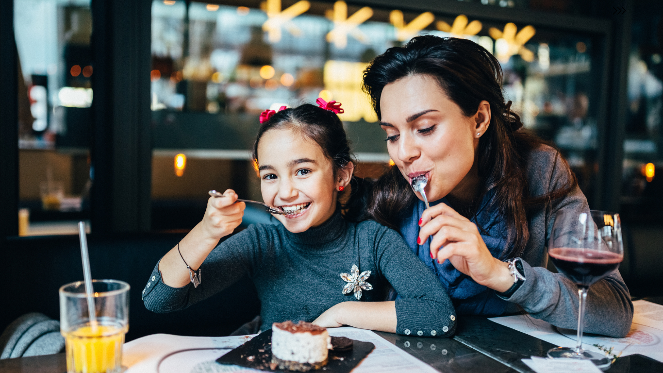 child eating at a restaurant with woman